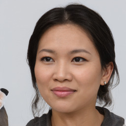 Joyful white young-adult female with medium  brown hair and brown eyes