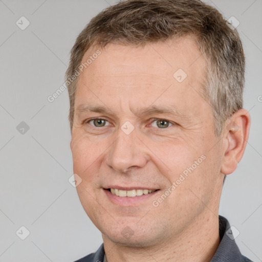 Joyful white adult male with short  brown hair and brown eyes