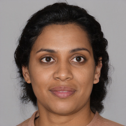 Joyful black young-adult female with medium  black hair and brown eyes