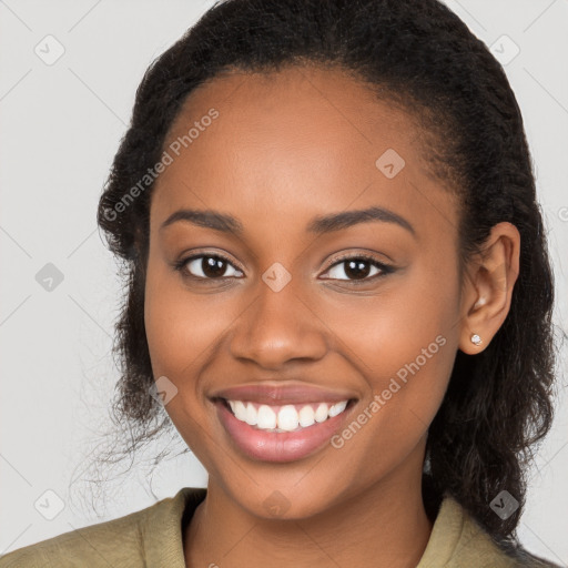 Joyful black young-adult female with long  brown hair and brown eyes