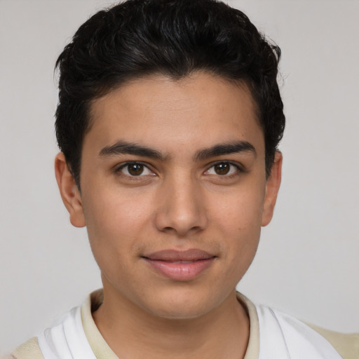 Joyful latino young-adult male with short  brown hair and brown eyes