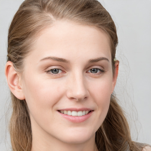 Joyful white young-adult female with long  brown hair and grey eyes