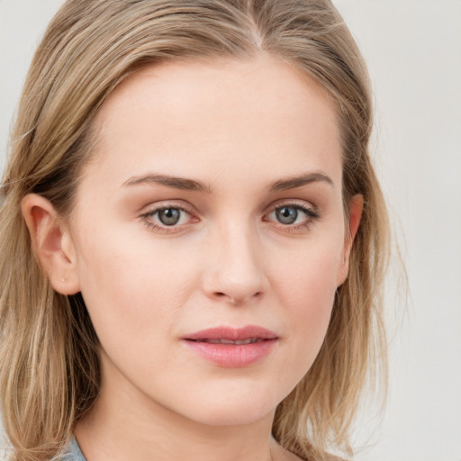 Joyful white young-adult female with long  brown hair and blue eyes