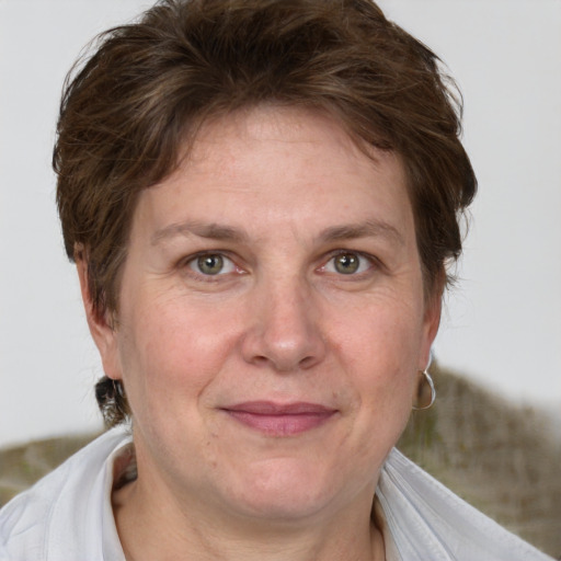 Joyful white adult female with medium  brown hair and grey eyes