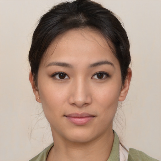 Joyful asian young-adult female with short  brown hair and brown eyes