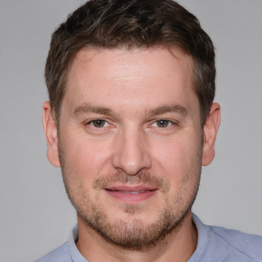 Joyful white adult male with short  brown hair and brown eyes