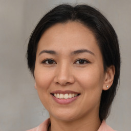 Joyful asian young-adult female with medium  brown hair and brown eyes