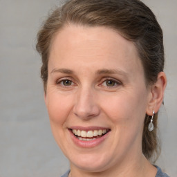 Joyful white adult female with medium  brown hair and brown eyes