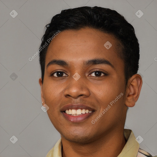 Joyful black young-adult male with short  black hair and brown eyes