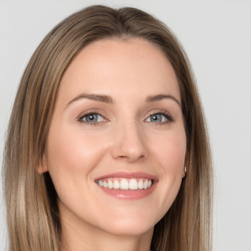 Joyful white young-adult female with long  brown hair and grey eyes