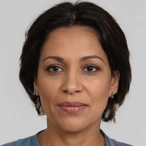 Joyful white adult female with medium  brown hair and brown eyes