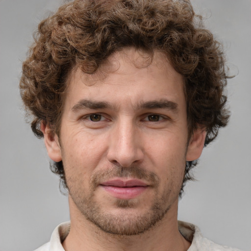 Joyful white young-adult male with short  brown hair and green eyes