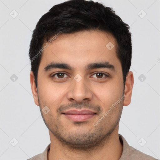 Joyful latino young-adult male with short  brown hair and brown eyes