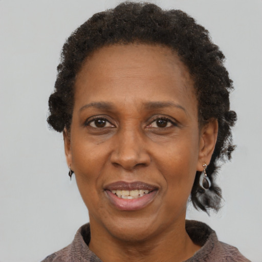Joyful black adult female with short  brown hair and brown eyes