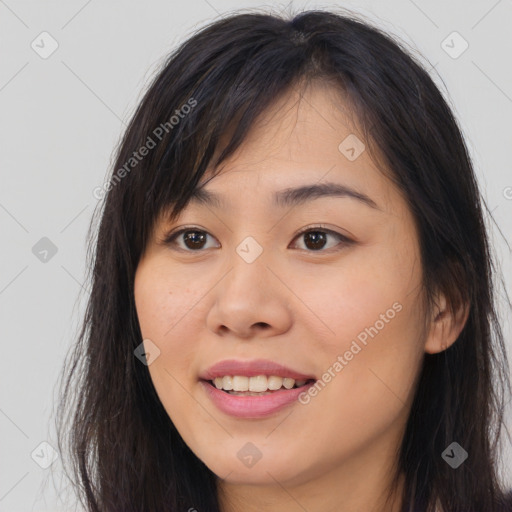 Joyful asian young-adult female with long  brown hair and brown eyes