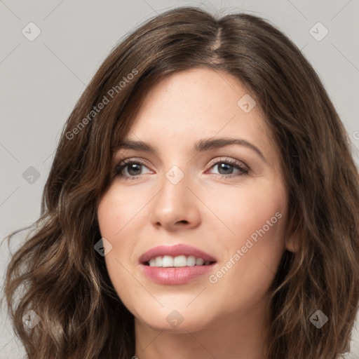 Joyful white young-adult female with long  brown hair and green eyes