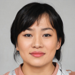 Joyful asian young-adult female with medium  black hair and brown eyes