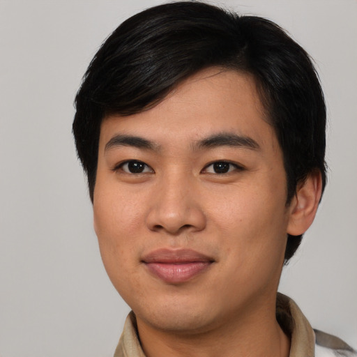 Joyful asian young-adult male with medium  brown hair and brown eyes