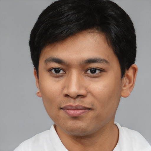 Joyful asian young-adult male with short  black hair and brown eyes