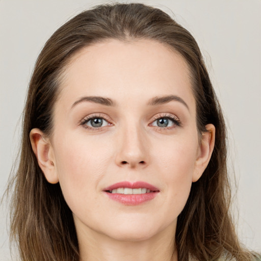 Joyful white young-adult female with long  brown hair and grey eyes