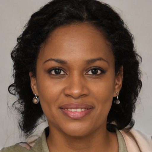Joyful black young-adult female with medium  brown hair and brown eyes