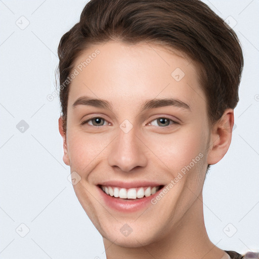 Joyful white young-adult female with short  brown hair and grey eyes