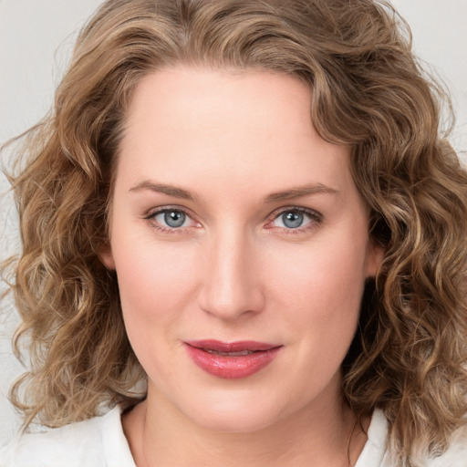 Joyful white young-adult female with medium  brown hair and blue eyes