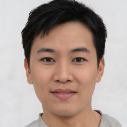 Joyful asian young-adult male with short  black hair and brown eyes