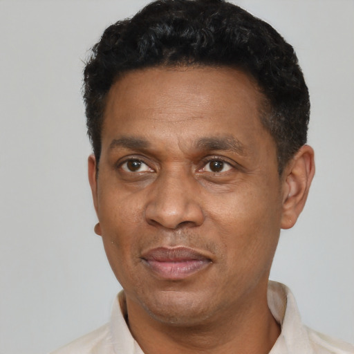 Joyful latino adult male with short  black hair and brown eyes