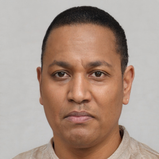 Neutral latino adult male with short  brown hair and brown eyes