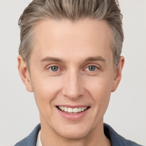 Joyful white adult male with short  brown hair and grey eyes