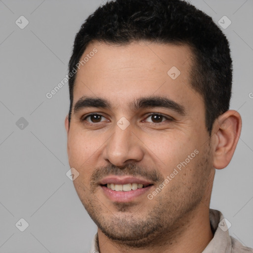 Joyful white young-adult male with short  black hair and brown eyes