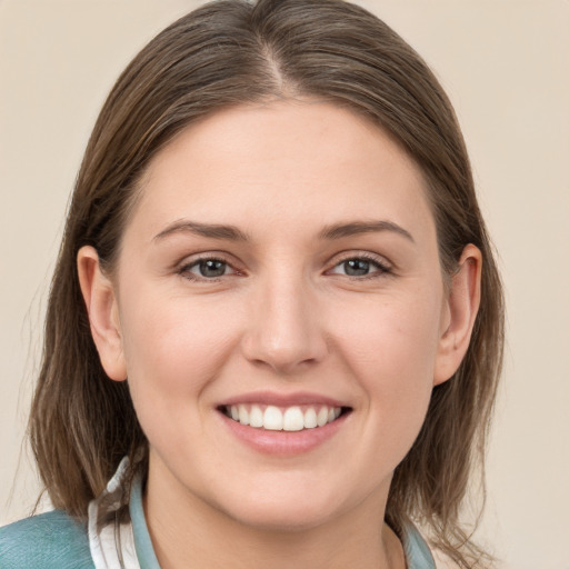 Joyful white young-adult female with medium  brown hair and grey eyes