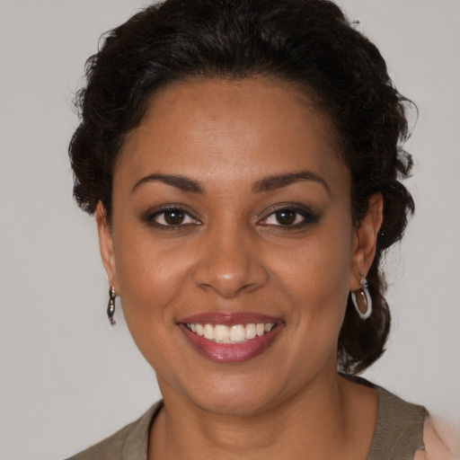 Joyful latino young-adult female with medium  brown hair and brown eyes