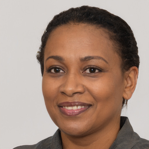 Joyful black adult female with short  black hair and brown eyes
