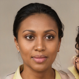 Joyful black young-adult female with medium  brown hair and brown eyes