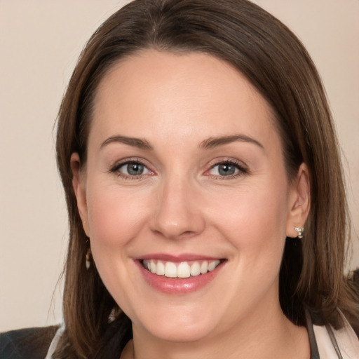 Joyful white young-adult female with medium  brown hair and grey eyes