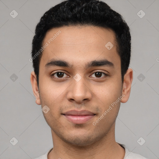 Joyful latino young-adult male with short  black hair and brown eyes