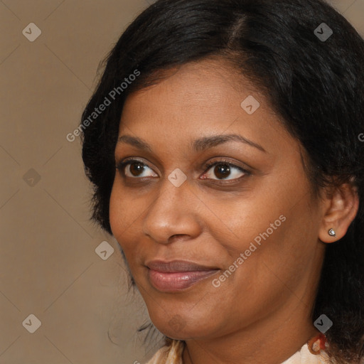 Joyful black adult female with medium  brown hair and brown eyes