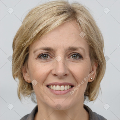 Joyful white adult female with medium  brown hair and grey eyes