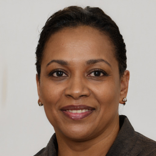 Joyful black adult female with short  black hair and brown eyes