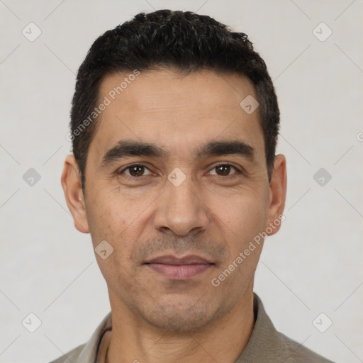 Joyful white adult male with short  black hair and brown eyes