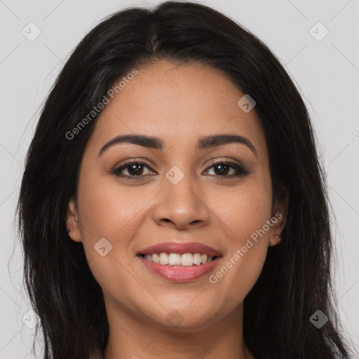 Joyful latino young-adult female with long  brown hair and brown eyes