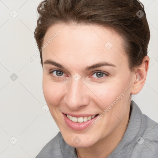 Joyful white young-adult female with short  brown hair and brown eyes