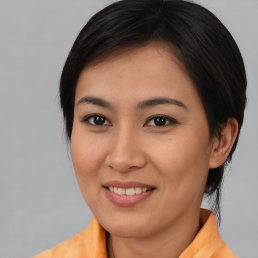 Joyful asian young-adult female with medium  brown hair and brown eyes