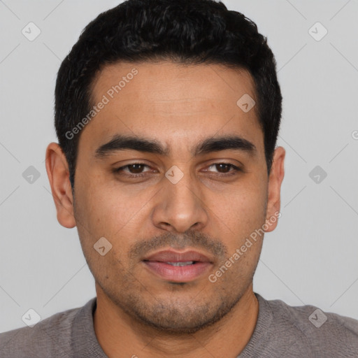 Joyful latino young-adult male with short  black hair and brown eyes
