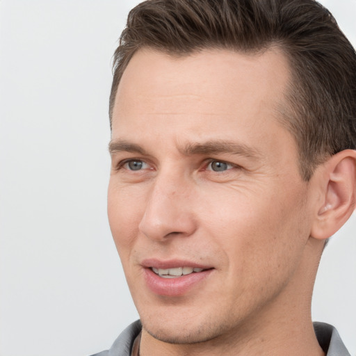 Joyful white adult male with short  brown hair and brown eyes