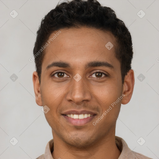 Joyful latino young-adult male with short  brown hair and brown eyes