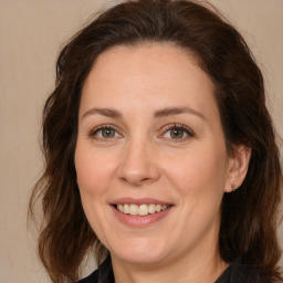 Joyful white adult female with medium  brown hair and brown eyes