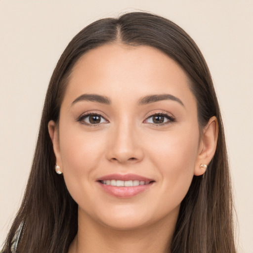 Joyful white young-adult female with long  brown hair and brown eyes